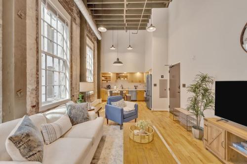 a living room with a couch and a tv at Heart of Downtown Knoxville in Knoxville