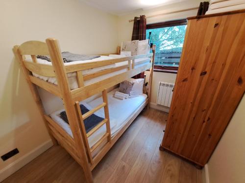 a couple of bunk beds in a room at Loch Ness Balcony Apartment in Drumnadrochit