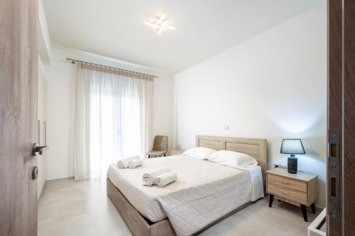 Ένα ή περισσότερα κρεβάτια σε δωμάτιο στο Blue Waters Suite Kos Centre