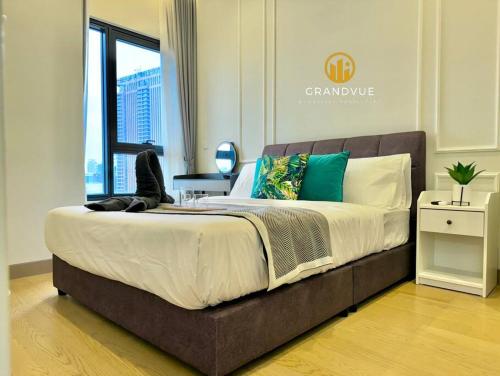 a large bed in a room with a window at Lucentia BukitBintang KlccView InfinityPool By HeyStay Management in Kuala Lumpur