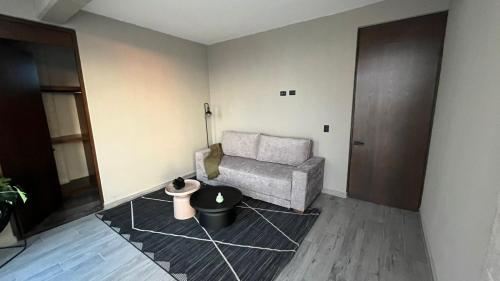 a living room with a chair and a table at Loft303 in Aguascalientes