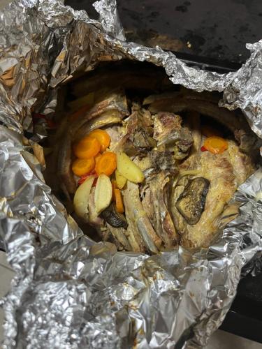 a meal of meat with vegetables and fruits in foil at Guesthouse Tanano/Dodo in Zhabeshi