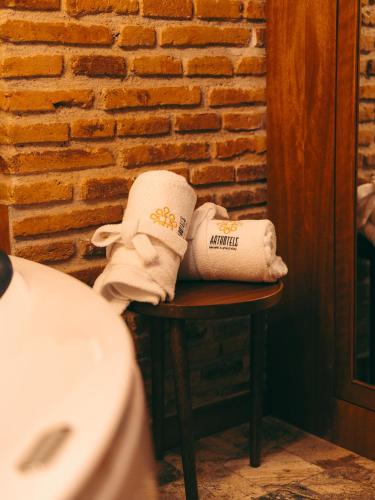 two towels sitting on a table in a bathroom at Hotel Cruz del Vado by Art Hotels in Cuenca
