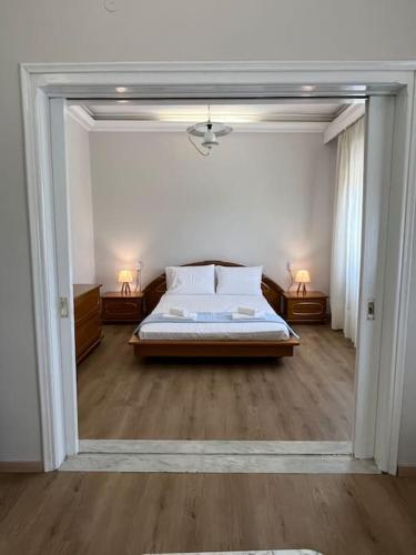 a bedroom with a bed and a large window at Mary's Villa in Xanthi
