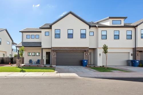 a large white house with a garage at Ocotillo Springs Resort 45 l Brand New Property, Private Pool, Hot Tub, & Community Pool in Santa Clara