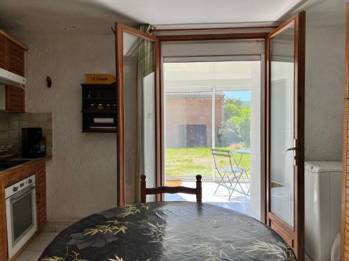 a kitchen with a sliding glass door to a patio at La Charmante in Le Vigan