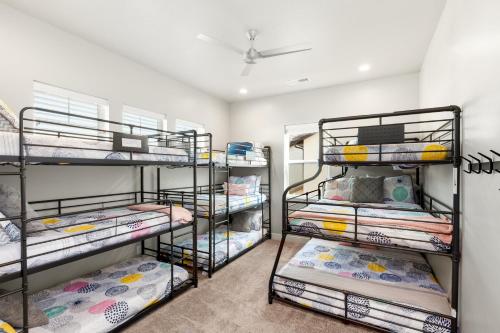 a room with three bunk beds in it at Ocotillo Springs Resort 45 l Brand New Property, Private Pool, Hot Tub, & Community Pool in Santa Clara