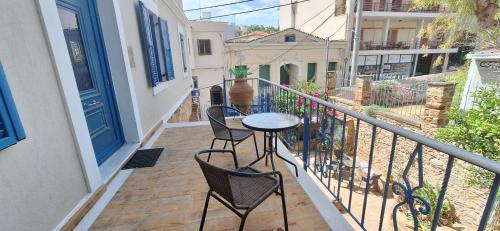 a balcony with a table and chairs on a building at KAMPANI STUDIO in Chios
