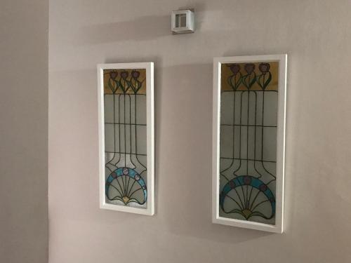 two stained glass windows on a wall at Boutique Hotel Mamabels in Mojácar