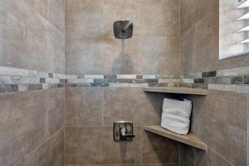 a bathroom with a shower with a towel at Ocotillo Springs 67 Low Prices, Private Hot Tub, Pool, Basketball Arcade, Ping Pong and Community Pool in Santa Clara
