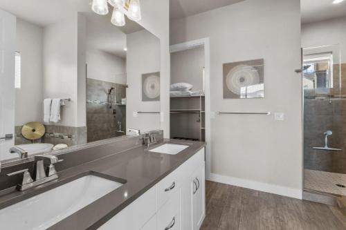 a bathroom with a sink and a large mirror at Ocotillo Springs 67 Low Prices, Private Hot Tub, Pool, Basketball Arcade, Ping Pong and Community Pool in Santa Clara