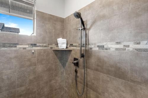 a shower with a glass door in a bathroom at Ocotillo Springs 67 Low Prices, Private Hot Tub, Pool, Basketball Arcade, Ping Pong and Community Pool in Santa Clara