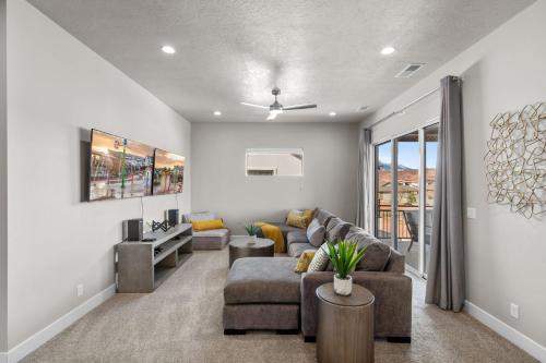 a living room with a couch and a tv at Ocotillo Springs 67 Low Prices, Private Hot Tub, Pool, Basketball Arcade, Ping Pong and Community Pool in Santa Clara