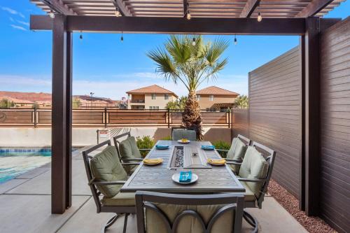 a patio with a table and chairs and a pool at Ocotillo Springs 67 Low Prices, Private Hot Tub, Pool, Basketball Arcade, Ping Pong and Community Pool in Santa Clara