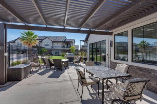 an outdoor patio with a table and chairs at Ocotillo Springs 67 Low Prices, Private Hot Tub, Pool, Basketball Arcade, Ping Pong and Community Pool in Santa Clara