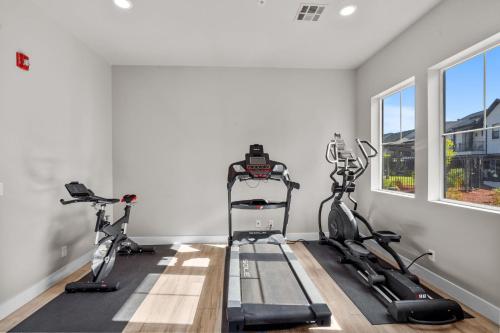 a gym with three exercise bikes in a room at Ocotillo Springs 67 Low Prices, Private Hot Tub, Pool, Basketball Arcade, Ping Pong and Community Pool in Santa Clara
