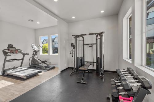 a gym with several treadmills and exercise machines at Ocotillo Springs 67 Low Prices, Private Hot Tub, Pool, Basketball Arcade, Ping Pong and Community Pool in Santa Clara