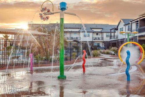 a water park with a fountain with people in it at Ocotillo Springs 67 Low Prices, Private Hot Tub, Pool, Basketball Arcade, Ping Pong and Community Pool in Santa Clara
