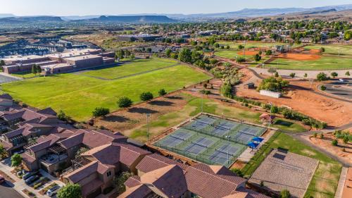 an aerial view of a house with a lawn and a tennis court at Ocotillo Springs 67 Low Prices, Private Hot Tub, Pool, Basketball Arcade, Ping Pong and Community Pool in Santa Clara