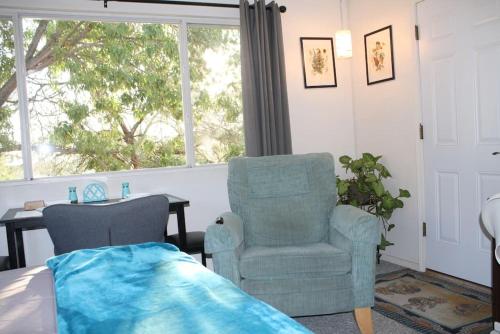a bedroom with a chair and a desk and a window at Work and Play Close to Sedona in Clarkdale