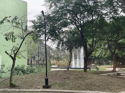 a pole in a park with trees and a fountain at Samruddhi S3 homestay garden villa or S1 in Nagpur