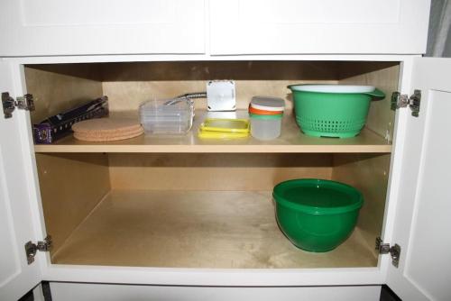 a cabinet filled with bowls and other kitchen items at Work and Play Close to Sedona in Clarkdale