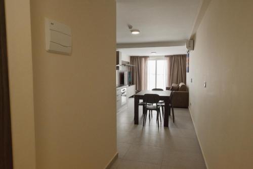 a kitchen and dining room with a table and chairs at 51HH Apartments in Il-Gżira