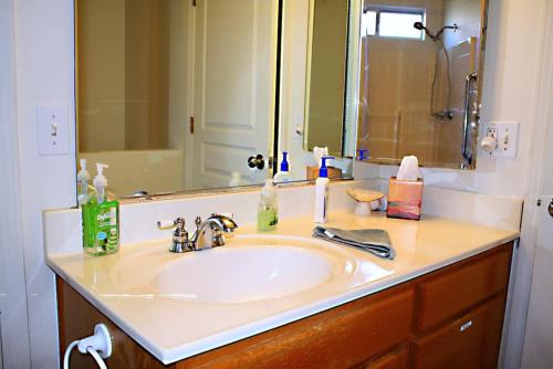 a bathroom counter with a sink and a mirror at Work and Play Close to Sedona in Clarkdale
