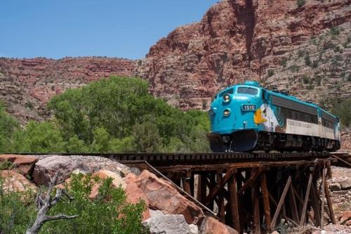 a blue train on a bridge in the desert at Work and Play Close to Sedona in Clarkdale