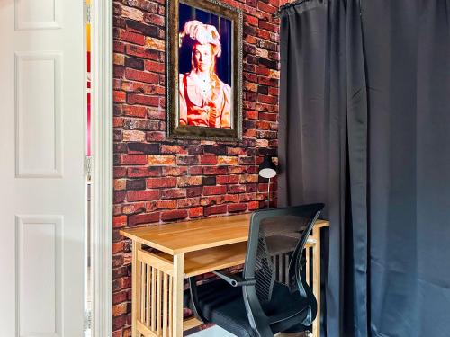 a brick wall with a wooden table and a chair at Themed house with private Game Room and Pool in Loughman