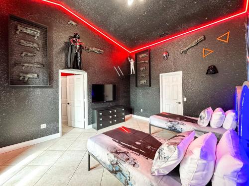 a room with two beds and a red light at Themed house with private Game Room and Pool in Loughman