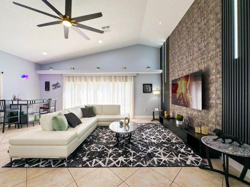 a living room with a couch and a table at Themed house with private Game Room and Pool in Loughman
