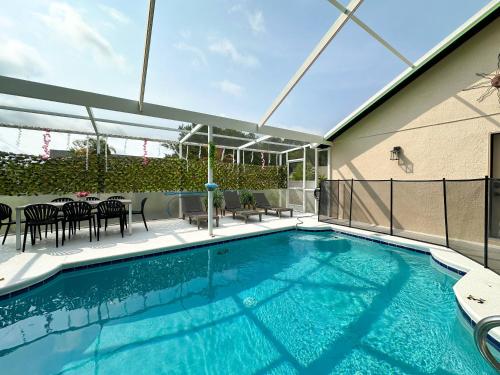 a swimming pool on a balcony with a table and chairs at Themed house with private Game Room and Pool in Loughman