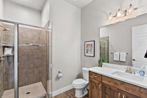 a bathroom with a shower and a toilet and a sink at Ocotillo 69 3 Bedrooms with a Private Hot Tub, Fire Pit, and Private Patio in Santa Clara