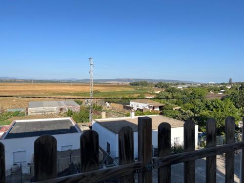 a view from the balcony of a house with a fence at Casa La Oliva Vejer in Vejer de la Frontera