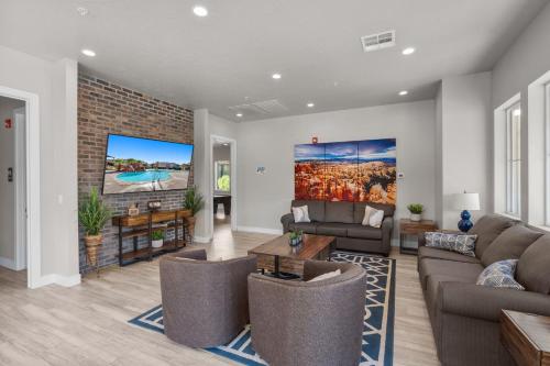a living room with a couch and a tv at Ocotillo 69 3 Bedrooms with a Private Hot Tub, Fire Pit, and Private Patio in Santa Clara
