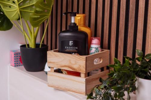 a wooden box with a bottle of soap and a plant at sunny & cozy - Netflix - WIFI - City - 4 Person in Essen