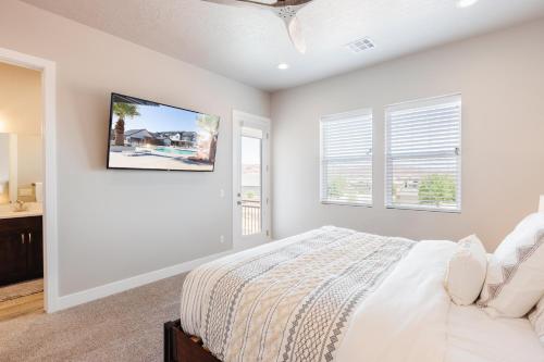 a bedroom with a bed and two windows at Ocotillo 70 Red Mountain View Resort, Private Pool & Hot Tub in Santa Clara