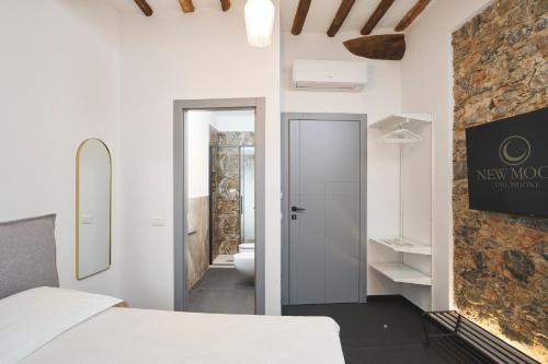a white room with a bed and a bathroom at New Moon Del prione in La Spezia