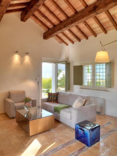 a living room with a couch and a table at Torre Fiore Hotel Masseria in Pisticci