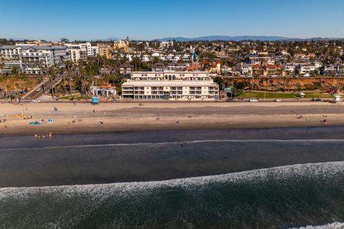 an aerial view of a beach with people and buildings at Southern California Beach Club in Oceanside