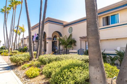 a building with palm trees in front of it at Southern California Beach Club in Oceanside