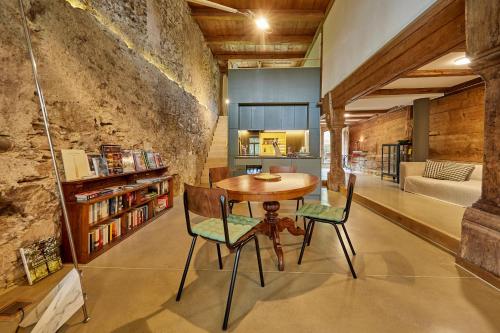 a dining room with a wooden table and chairs at Baudenkmal Mühle Schalchen in Wildberg