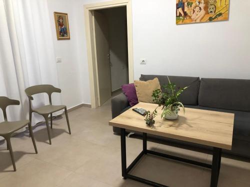 a living room with a couch and a table and chairs at Villa Arli&Eris in Vlorë
