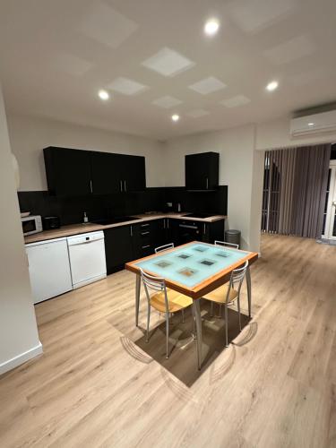 une cuisine avec une table et des chaises dans une pièce dans l'établissement Le refuge du littoral n8, à Grimaud