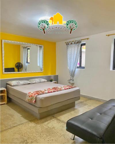 a bedroom with a bed and a chair and a mirror at Finca Amarelo casa campestre cap 35 pers in Cali
