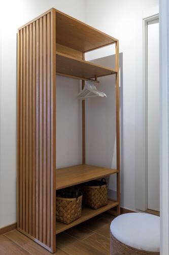 a room with a closet with wooden shelves at Hygge al Conero - Marcelli in Marcelli