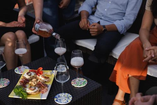 a person pouring wine into two wine glasses at Scario Club in San Giovanni a Piro