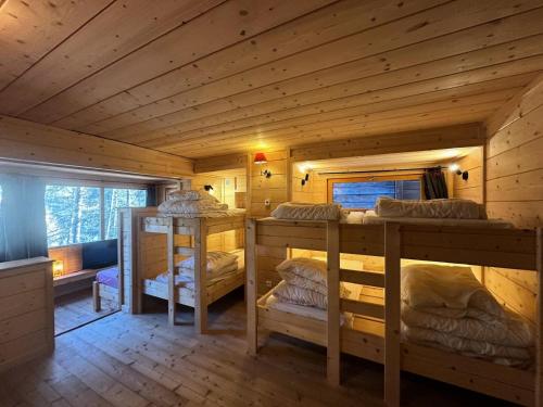 a room with four bunk beds in a log cabin at Résidence Le Flocon Ii - CHALET LE FLOCON Tout inclus MAE-1361 in Vars