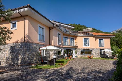 a large house with a patio in front of it at Scario Club in San Giovanni a Piro
